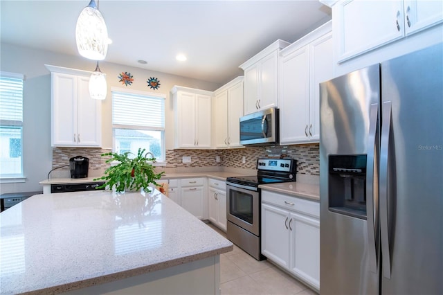 11728 Meadowgate Pl, Bradenton, FL 34211 - kitchen featuring stainless steel appliances, white cabinetry, backsplash, decorative light fixtures, and recessed lighting