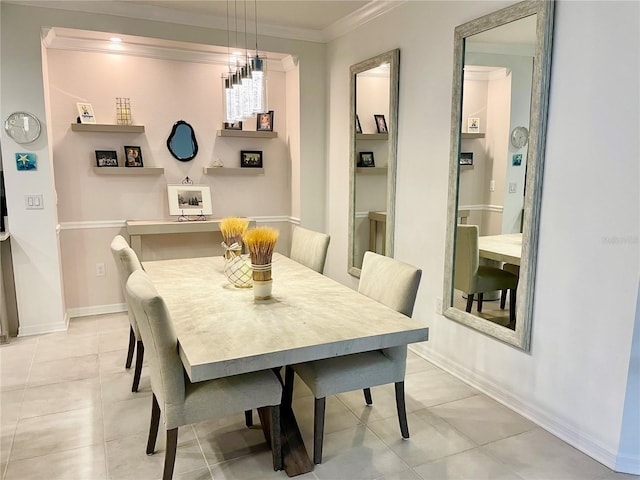 dining area with ornamental molding and light tile patterned flooring