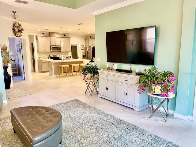 living room with crown molding and light tile patterned floors