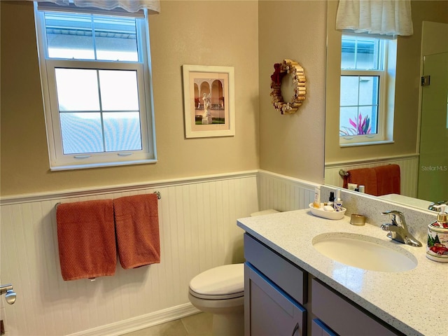 bathroom with tile patterned flooring, vanity, and toilet