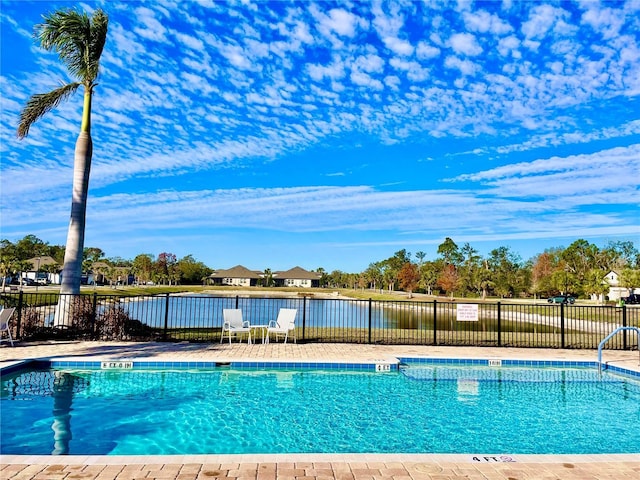 view of swimming pool with a water view