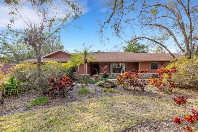 ranch-style home with a front lawn