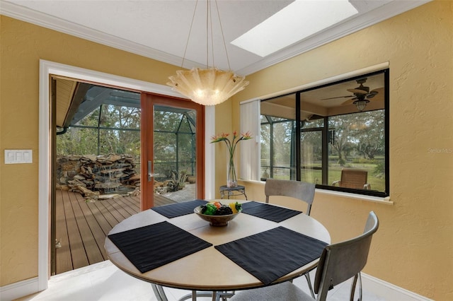 dining room with ornamental molding and a skylight