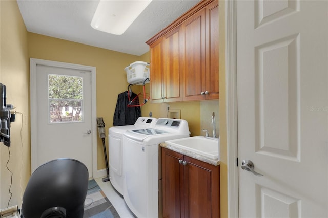 washroom featuring cabinets, independent washer and dryer, and sink