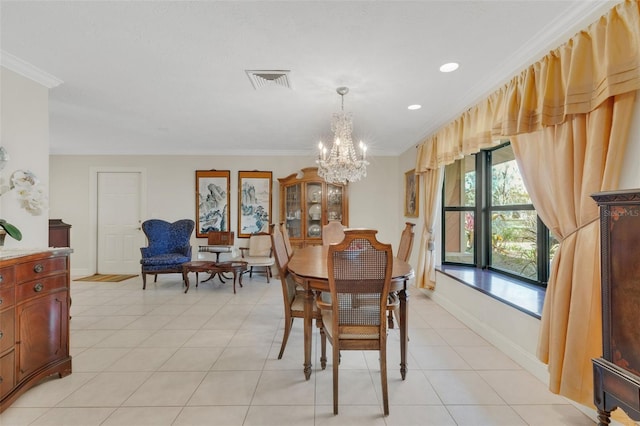 dining space with an inviting chandelier, ornamental molding, and light tile patterned flooring