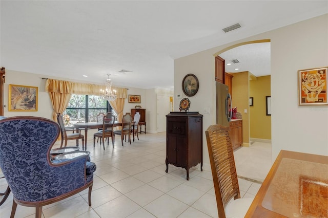 dining room featuring light tile patterned floors and a notable chandelier