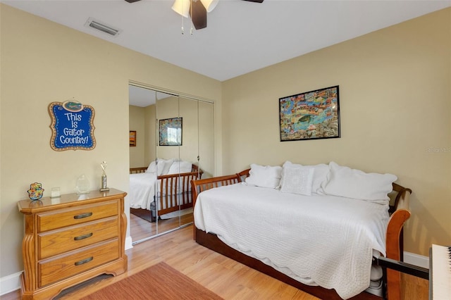 bedroom featuring light hardwood / wood-style floors, a closet, and ceiling fan