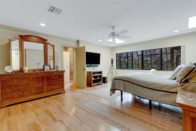 bedroom with ceiling fan, ornamental molding, and light hardwood / wood-style flooring