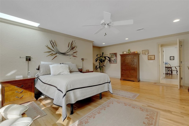 bedroom featuring ornamental molding, ceiling fan, and light wood-type flooring