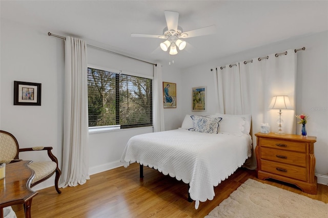 bedroom with wood-type flooring and ceiling fan