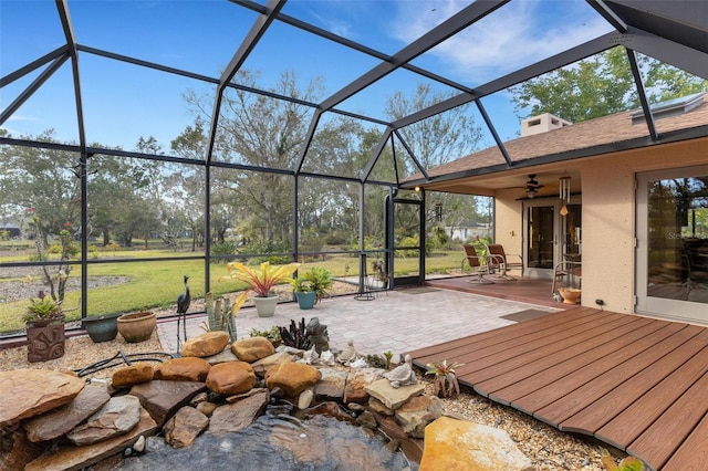 view of patio / terrace with ceiling fan and a lanai