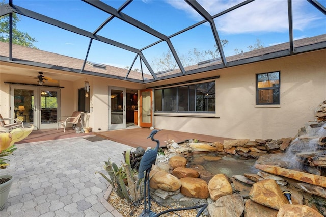 back of house with a lanai, a patio, ceiling fan, and french doors