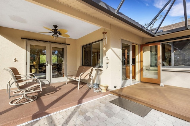 view of patio with a lanai, ceiling fan, and french doors