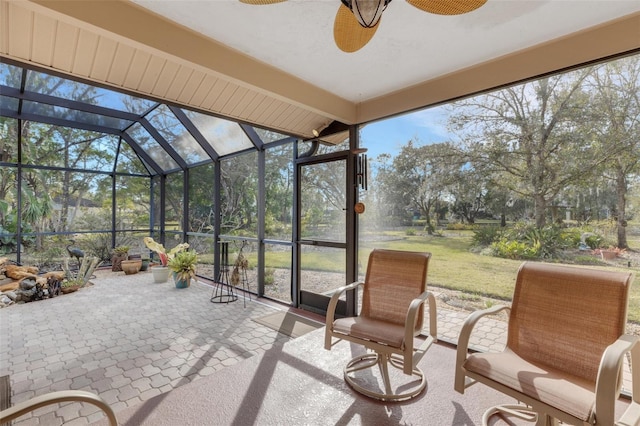 sunroom / solarium featuring ceiling fan, vaulted ceiling, and a wealth of natural light