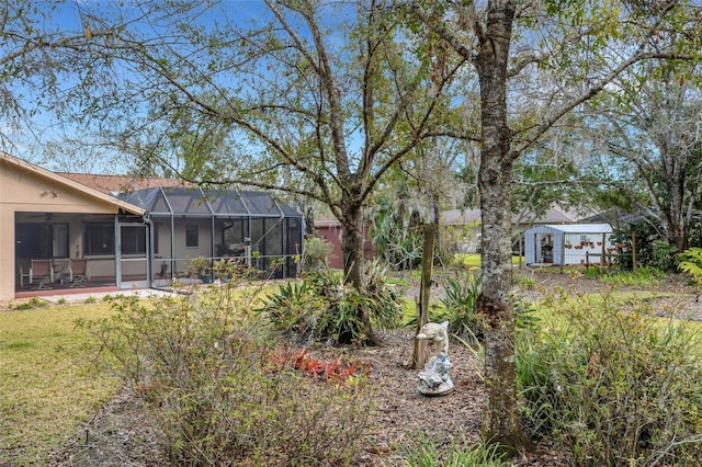 view of yard with glass enclosure