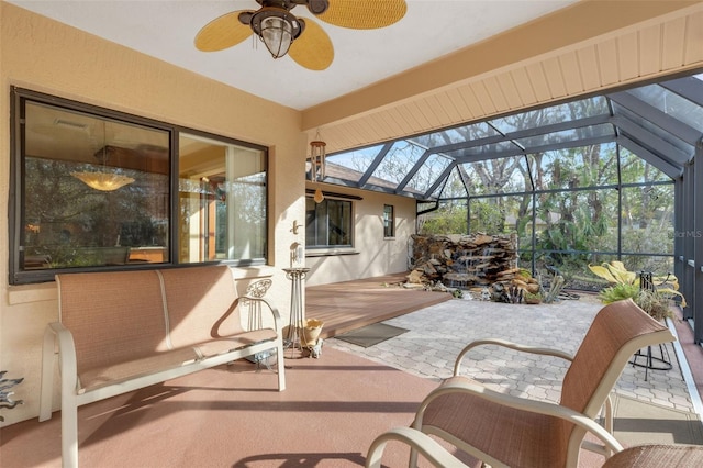 sunroom featuring ceiling fan