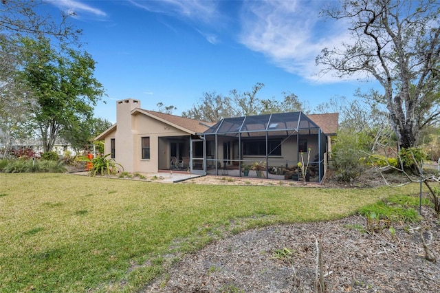 back of property featuring a patio area, glass enclosure, and a lawn