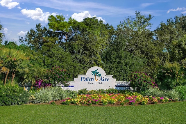 community / neighborhood sign with a lawn