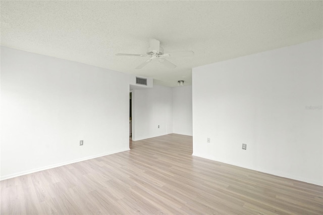 empty room with light hardwood / wood-style floors, a textured ceiling, and ceiling fan