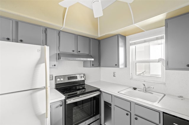 kitchen featuring sink, white refrigerator, gray cabinetry, and stainless steel range with electric stovetop