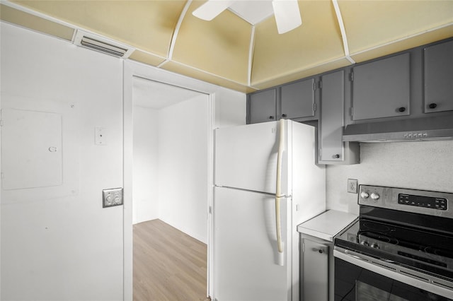 kitchen with white fridge, stainless steel electric range oven, light wood-type flooring, electric panel, and gray cabinetry