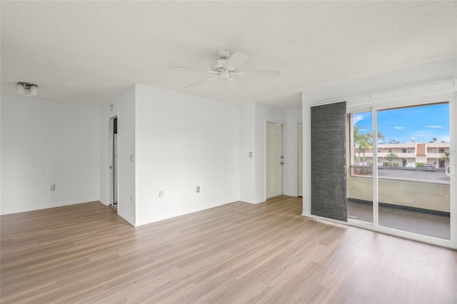 unfurnished room with ceiling fan, light hardwood / wood-style floors, and a textured ceiling