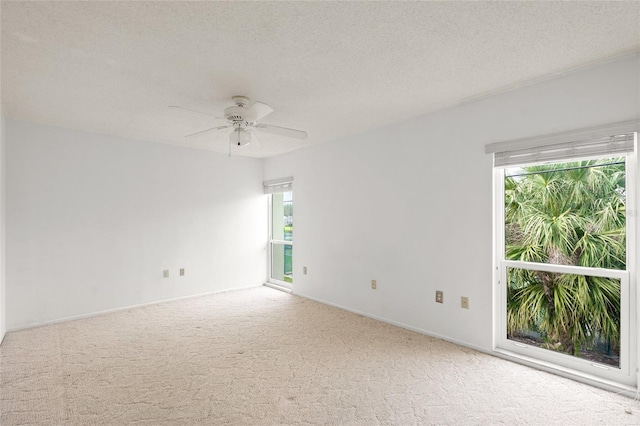 spare room with ceiling fan, a textured ceiling, and carpet flooring