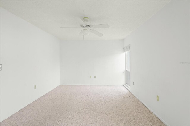 spare room featuring ceiling fan, carpet, and a textured ceiling