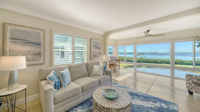 sunroom featuring a water view, plenty of natural light, and ceiling fan