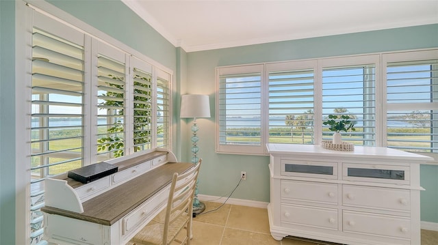 home office with light tile patterned floors, ornamental molding, and baseboards