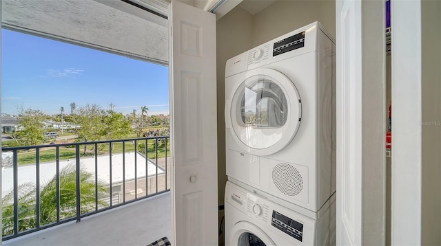 laundry room featuring stacked washer / drying machine