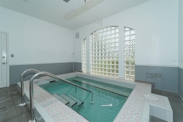 view of swimming pool with an indoor hot tub