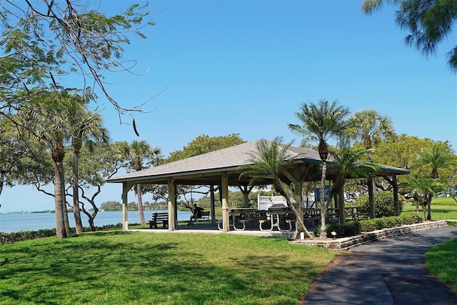 view of home's community with a yard, a gazebo, and a water view