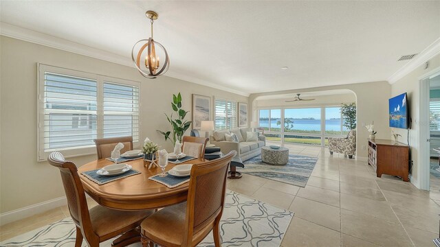 dining area with visible vents, crown molding, baseboards, and light tile patterned floors