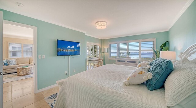 bedroom featuring light tile patterned flooring, crown molding, and baseboards