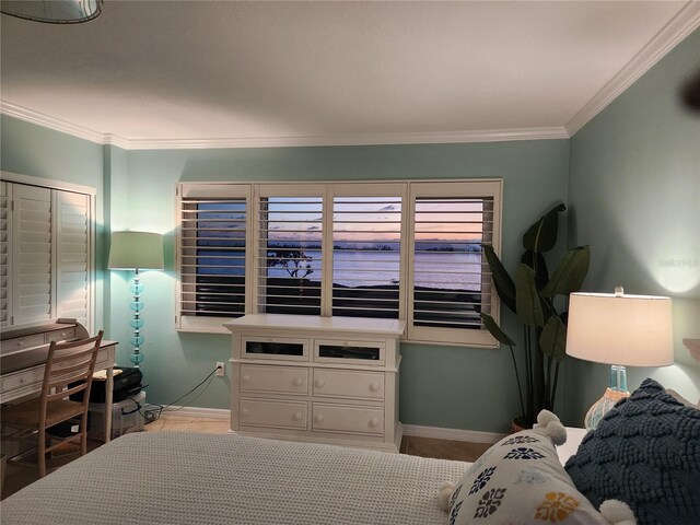 bedroom featuring crown molding and baseboards