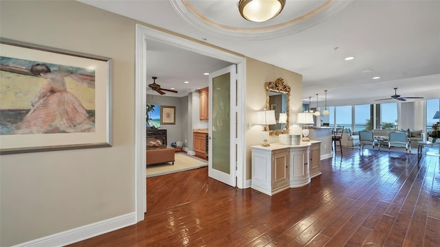 kitchen featuring decorative light fixtures, dark hardwood / wood-style flooring, and a tray ceiling