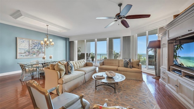 living room featuring dark hardwood / wood-style floors, ceiling fan with notable chandelier, and ornamental molding