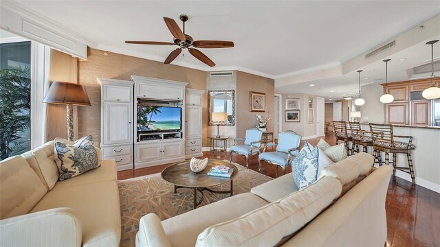 living room with ceiling fan, dark hardwood / wood-style floors, and crown molding