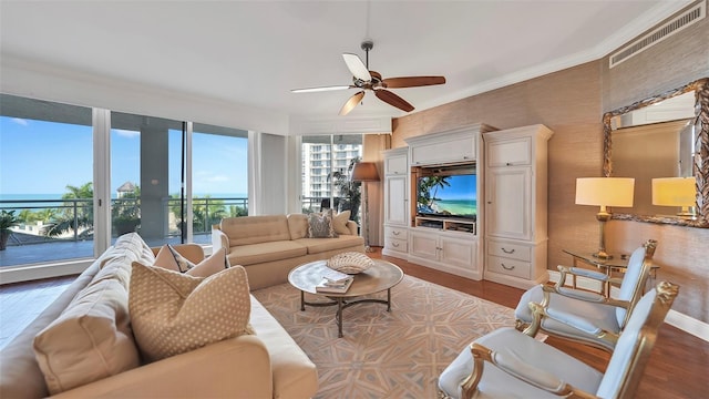 living room featuring ceiling fan, a healthy amount of sunlight, and light hardwood / wood-style floors