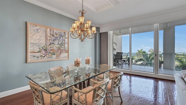 dining space with ornamental molding, a healthy amount of sunlight, dark hardwood / wood-style floors, and a notable chandelier