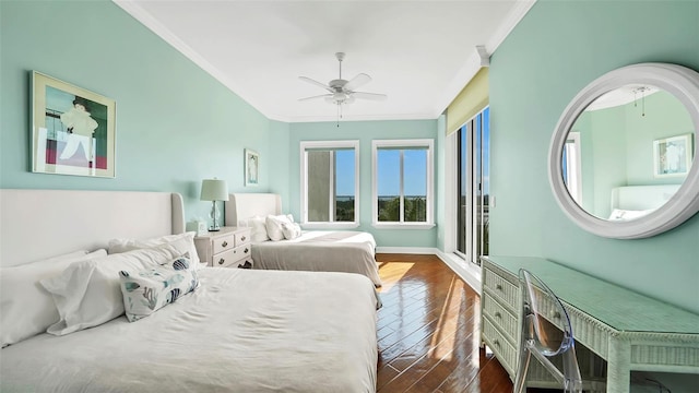 bedroom with ceiling fan, dark wood-type flooring, and ornamental molding