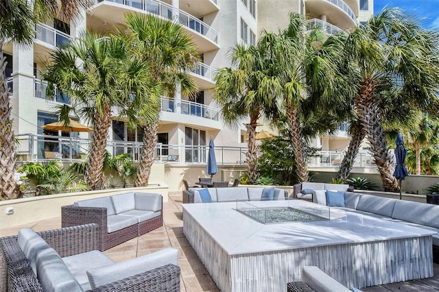 exterior space featuring a patio area and an outdoor living space with a fire pit