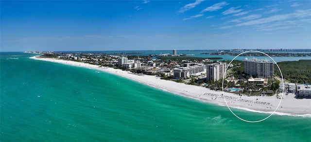 bird's eye view featuring a water view and a view of the beach