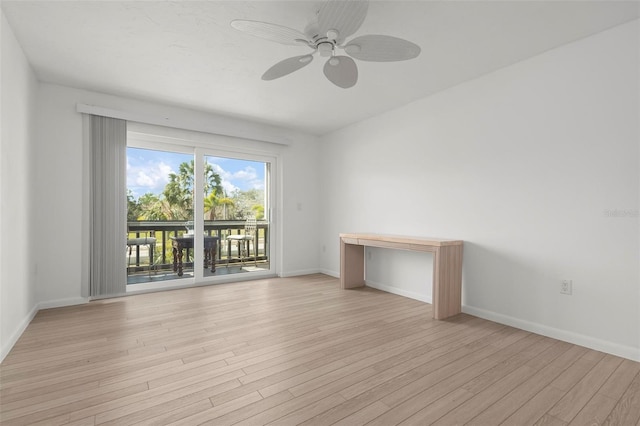 empty room featuring light wood-type flooring, a ceiling fan, and baseboards