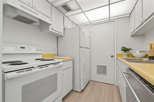 kitchen with light countertops, white appliances, under cabinet range hood, and white cabinets