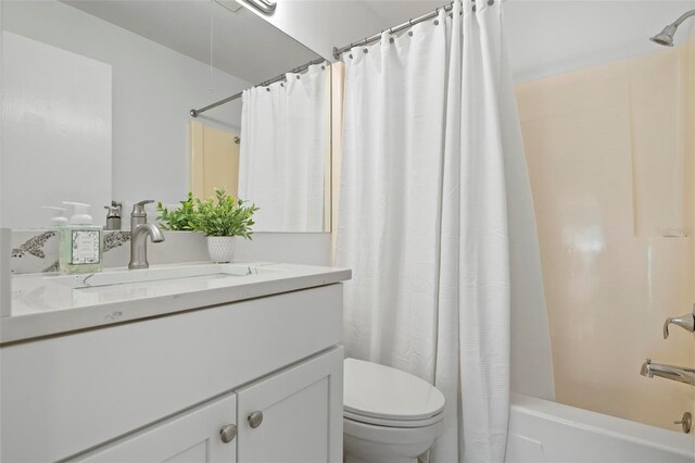 full bath featuring toilet, shower / bathtub combination with curtain, and vanity