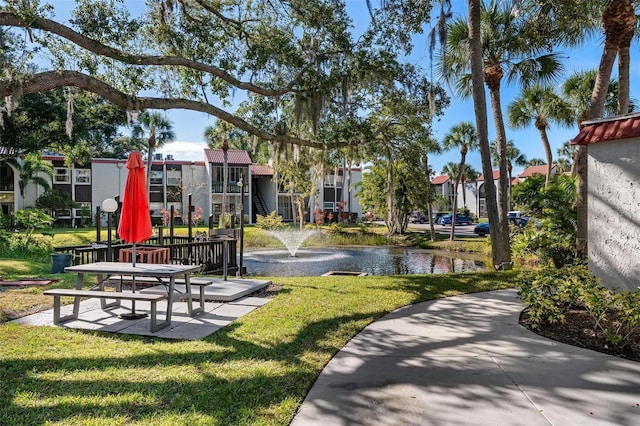 view of home's community featuring a yard and a water view