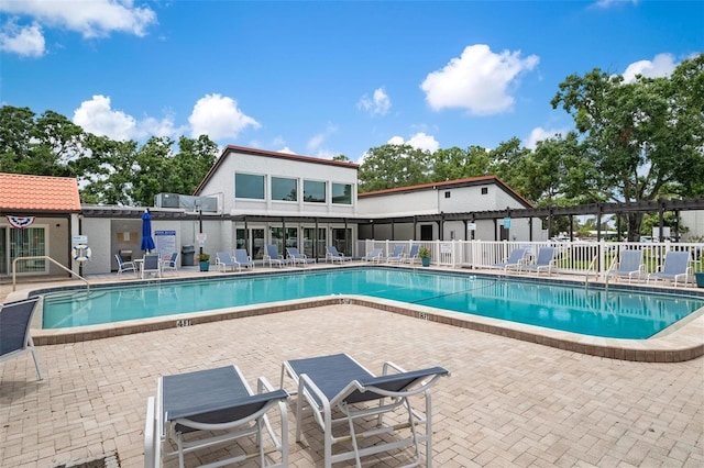 community pool featuring a patio area, fence, and a pergola