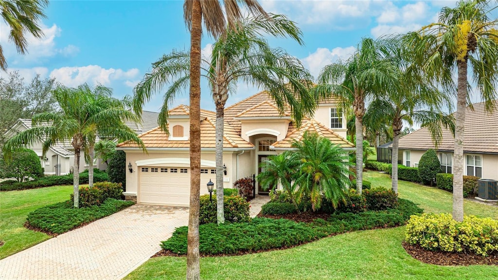 view of front facade with a garage and a front lawn